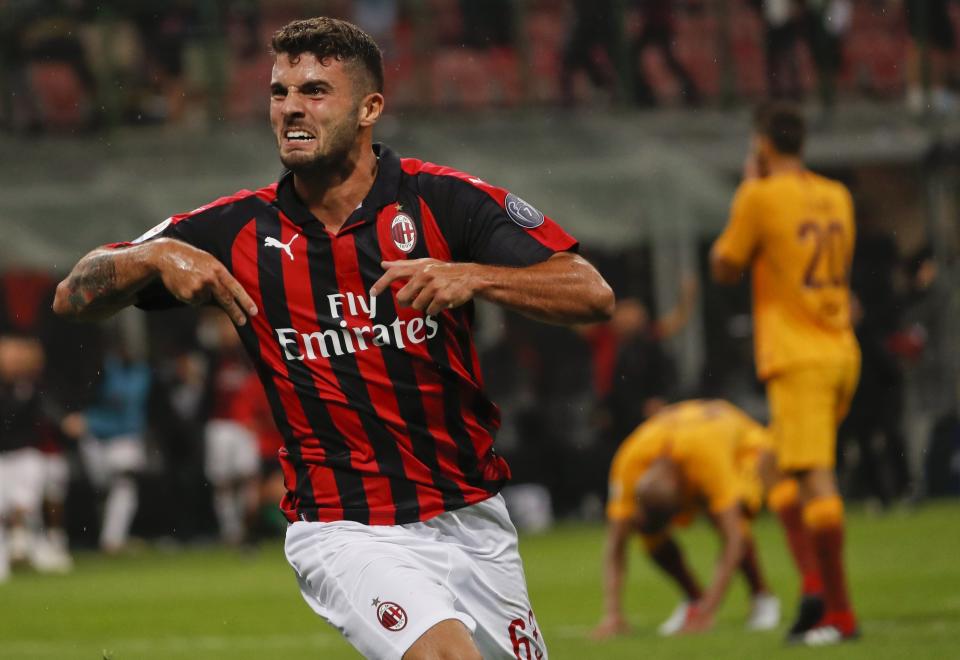 AC Milan's Patrick Cutrone celebrates after scoring his side's 2nd goal during the Serie A soccer match between AC Milan and Roma at the Milan San Siro Stadium, Italy, Friday, Aug. 31, 2018. AC Milan won 2-1. (AP Photo/Antonio Calanni)