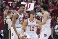Indiana's Trayce Jackson-Davis (23) reacts with Miller Kopp (12) and Trey Galloway, right, after Jackson-Davis hit a basket and was fouled during the first half of an NCAA college basketball game against Purdue, Saturday, Feb. 4, 2023, in Bloomington, Ind. (AP Photo/Darron Cummings)