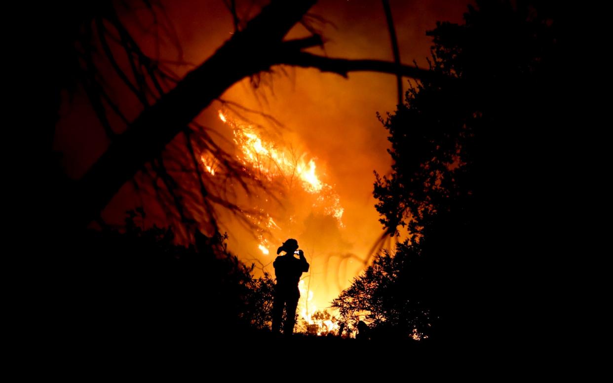 A firefighter tackles a wildfire in Montecito, California - AP