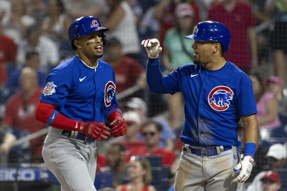 Chicago Cubs Christopher Morel, left, and Alfonso Rivas celebrate after they scored on Morel's RBI double and a throwing error by Philadelphia Phillies first baseman Rhys Hoskins during the fifth inning of a baseball game Friday, July 22, 2022, in Philadelphia. (AP Photo/Laurence Kesterson)