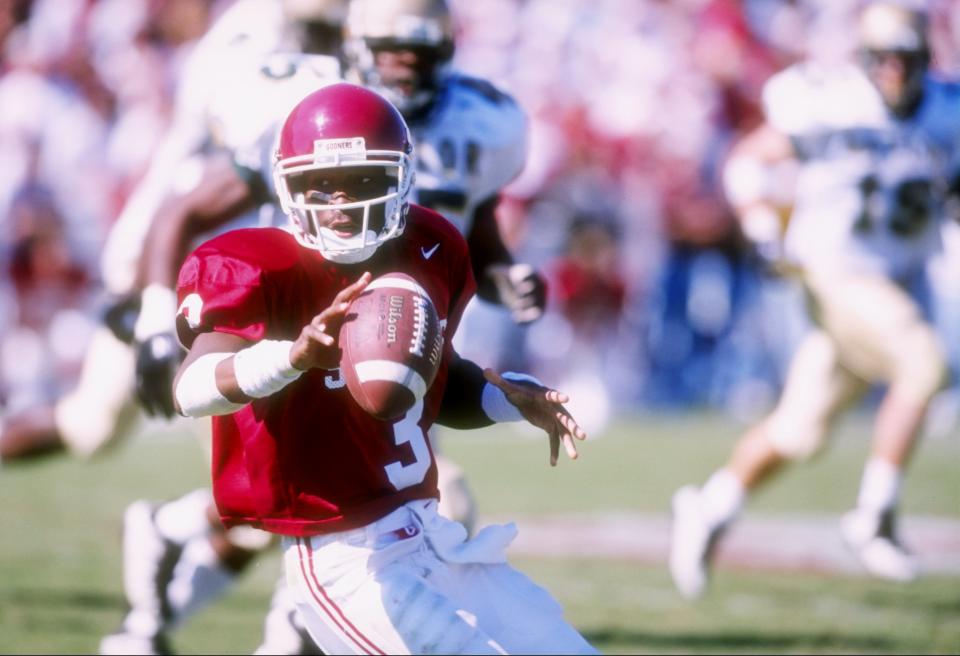 Oct. 18, 1997: Quarterback Eric Moore of the Oklahoma Sooners scrambles with the ball during a game against the Baylor Bears at Memorial Stadium in Norman, Oklahoma. Oklahoma won the game 24-23. Stephen Dunn /Allsport