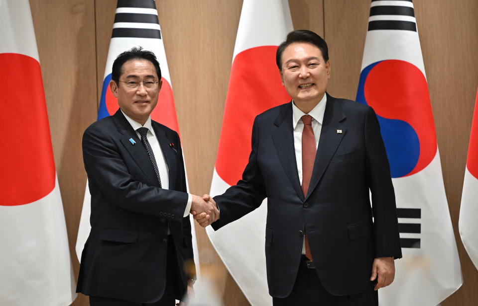 South Korean President Yoon Suk Yeol (R) shakes hands with Japanese Prime Minister Fumio Kishida (L) during their meeting at the presidential office on May 7, 2023 in Seoul, South Korea.  (Jung Yeon-Je - Pool/Getty Images / Jung Yeon-Je - Pool/Getty Images)