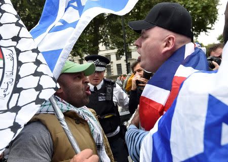 Demonstrators argue during a protest outside Downing Street in London, Britain September 9, 2015. REUTERS/Toby Melville