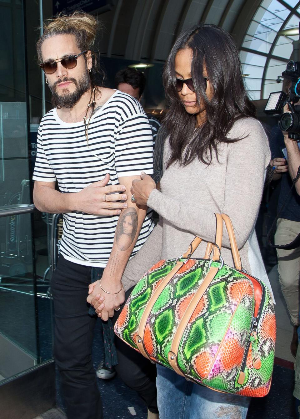 Zoe Saldana and Marco Perego seen at LAX on May 09, 2014 in Los Angeles, California