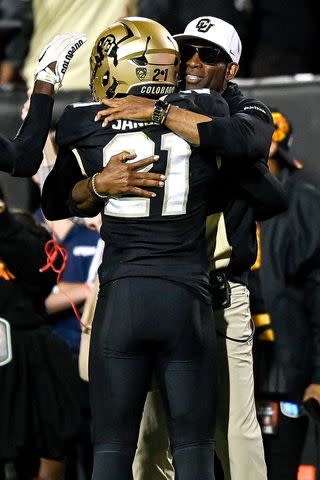 <p>Dustin Bradford/Getty</p> Shilo Sanders celebrates with his head coach and father Deion Sanders during the game, Sept. 16, in Boulder, CO.