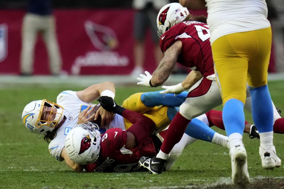 Chargers quarterback Justin Herbert (10) is sacked by Cardinals linebacker Isaiah Simmons.