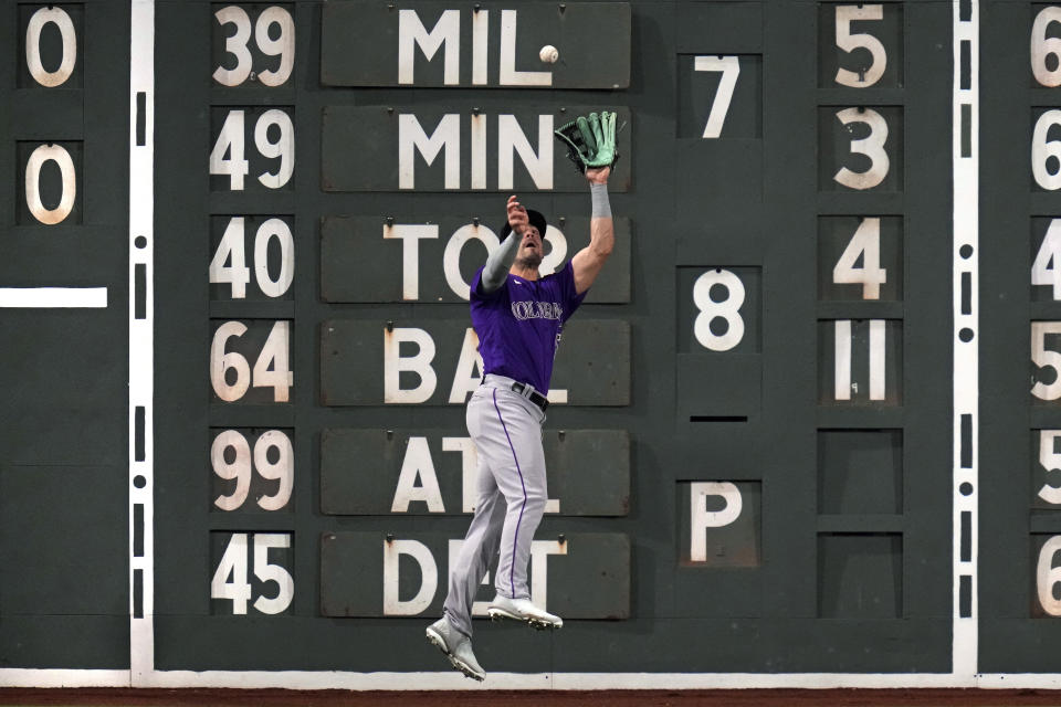 Colorado Rockies left fielder Randal Grichuk makes the catch on a lineout by Boston Red Sox's Christian Arroyo during the eighth inning ofp a baseball game at Fenway Park, Tuesday, June 13, 2023, in Boston. (AP Photo/Charles Krupa)