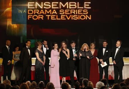 Actress Lesley Nicol (at microphone) is accompanied by members of the cast of "Downton Abbey" as they accept the award for Outstanding Performance by an Ensemble in a Drama Series at the 22nd Screen Actors Guild Awards in Los Angeles, California January 30, 2016. REUTERS/Lucy Nicholson