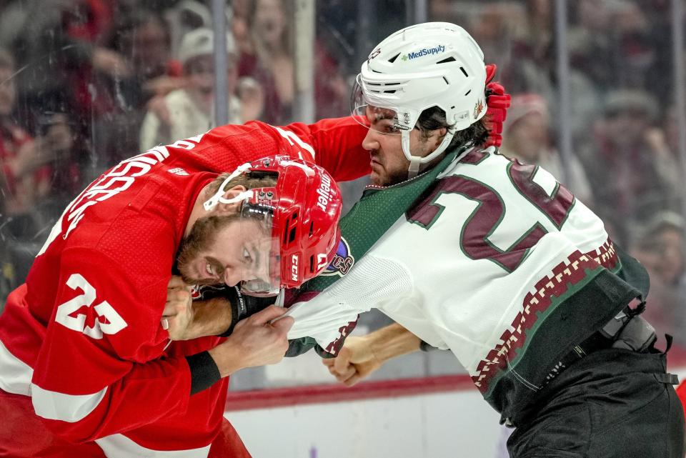 Michael Rasmussen of the Detroit Red Wings and Jack McBain of the Arizona Coyotes fight during the first period at Little Caesars Arena in Detroit on Friday, Nov. 25, 2022, in Detroit.