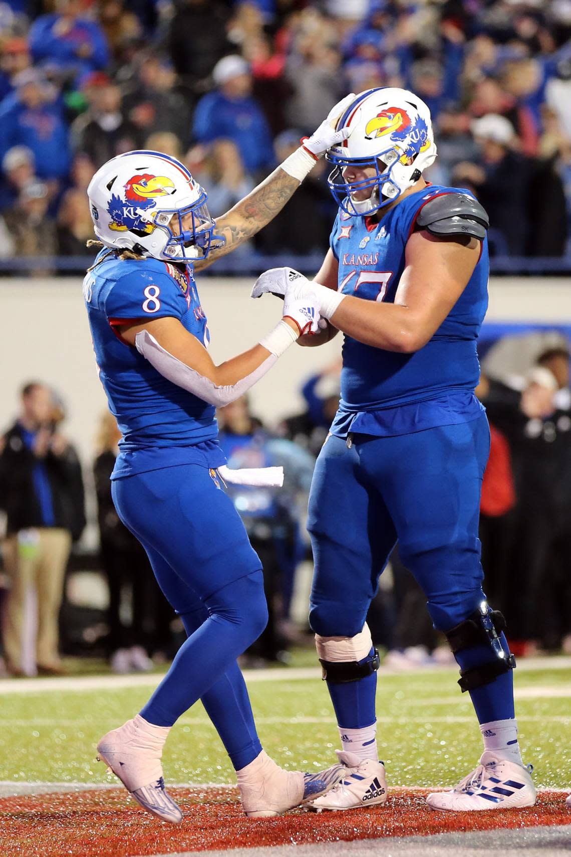 Kansas Jayhawks running back Ky Thomas (8) celebrates with left guard Dominick Puni (67) after scoring a touchdown against the Arkansas Razorbacks during the Liberty Bowl at Liberty Bowl Memorial Stadium on Dec. 28, 2022.