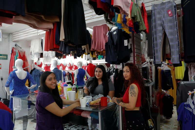 Vianey Maldonado, Selene Andrade and Jessica Escalante pose for a photo inside a clothes shop in Ecatepec