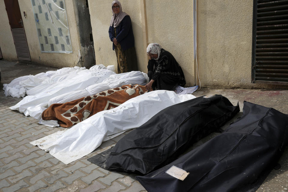Palestinians mourn over their relatives killed in the Israeli bombardments of the Gaza Strip at Al Aqsa Hospital in Deir al Balah, Gaza Strip, on Sunday, Feb. 18, 2024. (AP Photo/Adel Hana)