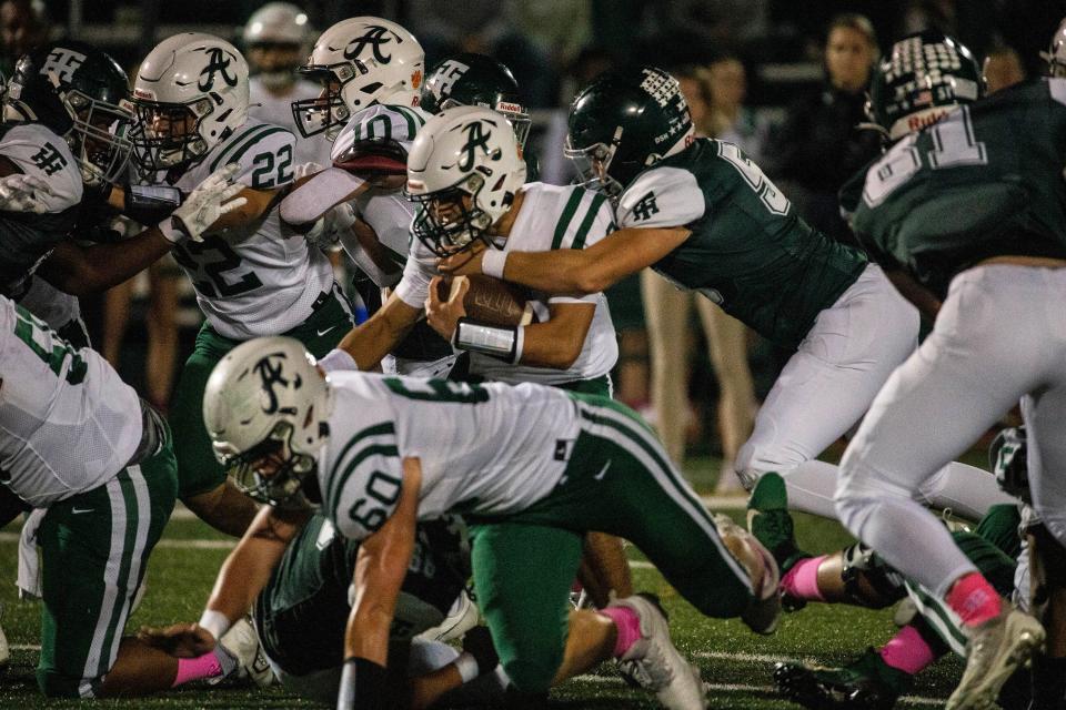 Archmere senior Mike Kempski (3) hangs on to the fall as Tower senior Keelan Donnelly (59) Hill goes for the takedown during the football game at the Tower Hill DeGroat Field in Wilmington, Friday, Oct. 20, 2023. Archmere won 44-6.