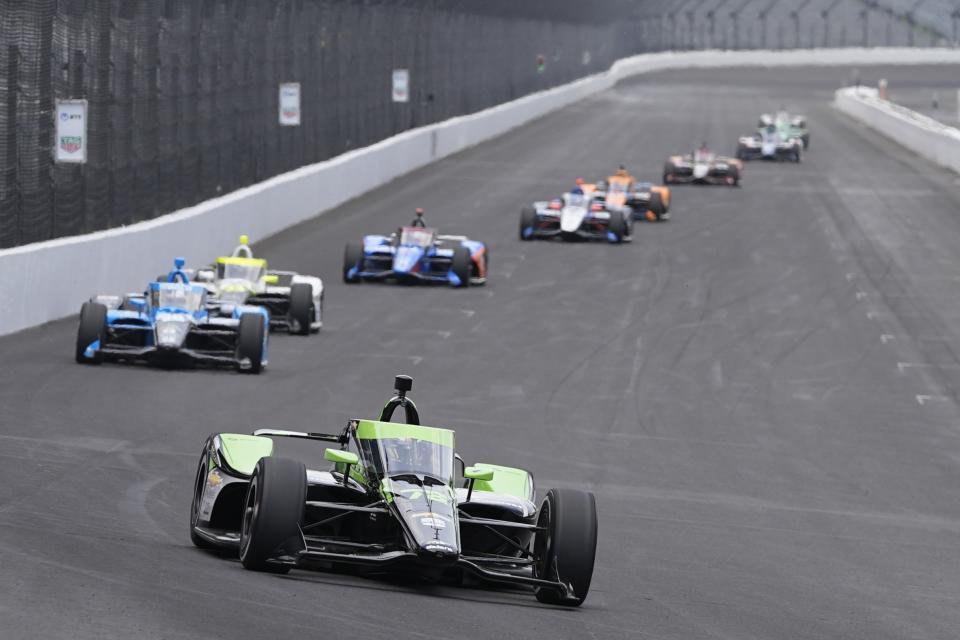 Agustin Canapino, of Argentina, leads a group of cars into a turn during a practice session for the Indianapolis 500 auto race at Indianapolis Motor Speedway, Monday, May 20, 2024, in Indianapolis. (AP Photo/Darron Cummings)