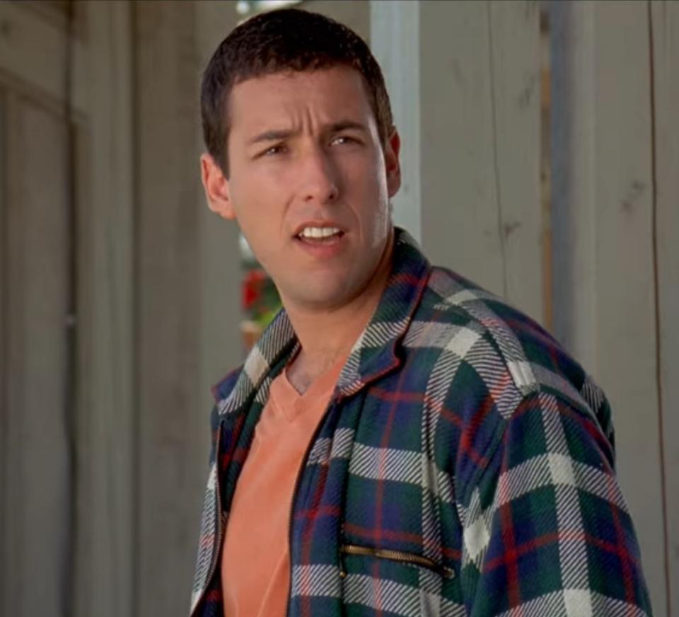 Adam Sandler as Happy Gilmore stands outside his grandma's house