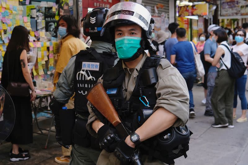 Riot police stand guard to avoid mass gathering during a protest against the looming national security legislation in Hong Kong
