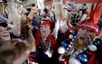 Houston Texans fans celebrate after the Houston Texans chose South Carolina defensive end Jadeveon Clowney as the number one overall pick in the NFL draft Thursday, May 8, 2014, in Houston. (AP Photo/David J. Phillip)