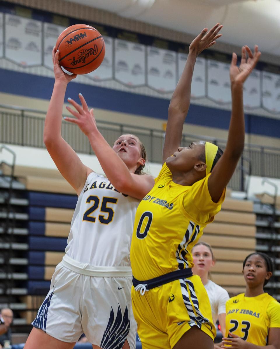 Hartland's Sarah Rekowski lays a shot around Wayne Memorial's Paris Bass during the Eagles' 51-39 loss on Tuesday, Dec. 20, 2022.