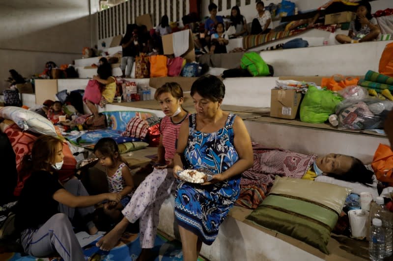 Manimtim sits with her family in an evacuation center for residents affected by the Taal Volcano eruption in Santo Tomas