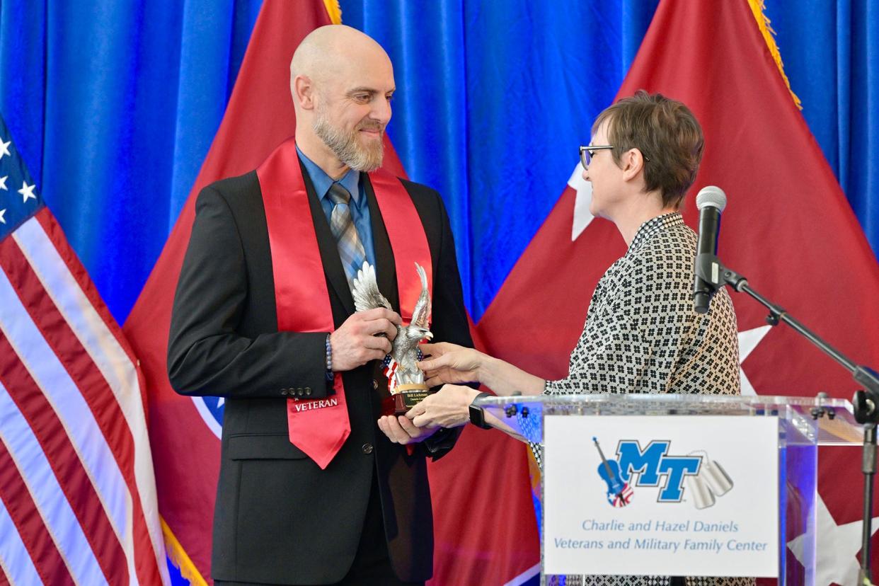 Middle Tennessee State University graduating senior student veteran Bill Lickman, left, accepts the Charlie and Hazel Daniels Veterans and Military Family Center Veteran Leadership Award from Laurie Witherow, interim vice provost for Enrollment Services, Thursday, May 2, during the Graduating Veterans Stole Ceremony at the Miller Education Center on Bell Street in Murfreesboro, Tenn. the award is given to a graduating student veteran who has demonstrated superior leadership, academic achievement and selfless service to MTSU and the Daniels Center community. Lickman was both a survivor and hero of the 9/11 terrorist attacks at the Pentagon in Washington, D.C., on Sept. 11, 2001.