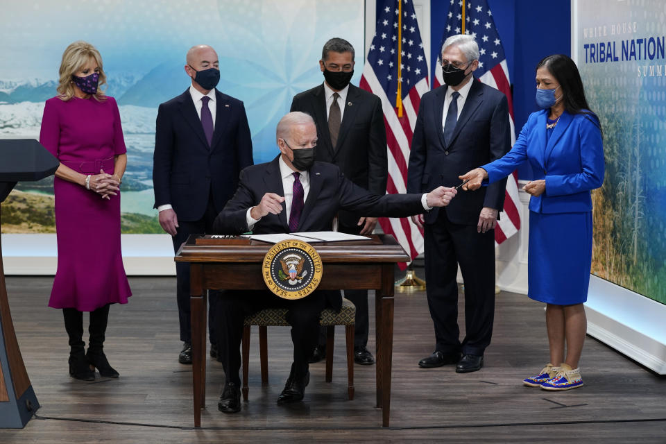 FILE - President Joe Biden hands a pen to Interior Secretary Deb Haaland after signing an executive order to help improve public safety and justice for Native Americans during a Tribal Nations Summit during Native American Heritage Month, Nov. 15, 2021, in Washington. With the President from left are first lady Jill Biden, Homeland Security Secretary Alejandro Mayorkas, Health and Human Services Secretary Xavier Becerra, Attorney General Merrick Garland and Interior Secretary Deb Haaland. A U.S. Supreme Court ruling expanding state authority to prosecute some crimes on Native American land is upending decades of law in support of tribal sovereignty. (AP Photo/Evan Vucci, File)