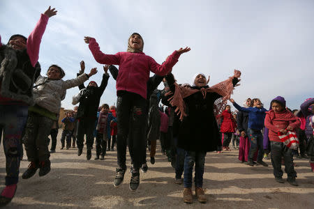 Students gesture as they stand in line at the 'Aisha Mother of the BelieversÕ school which was recently reopened after rebels took control of al-Rai town from Islamic State militants, Syria January 16, 2017. Picture taken January 16, 2017. REUTERS/Khalil Ashawi