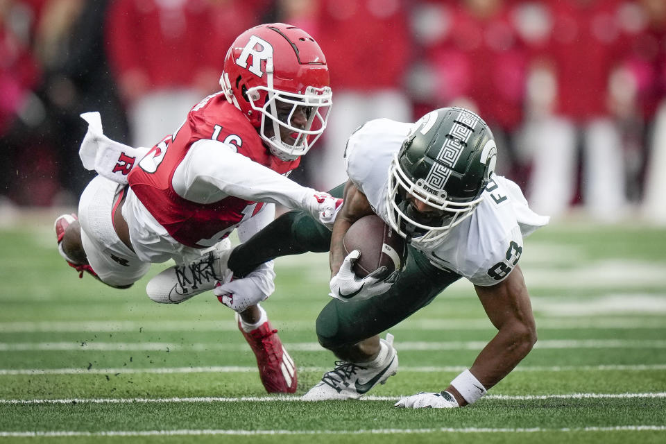 Rutgers defensive back Max Melton (16) tackles Michigan State wide receiver Montorie Foster Jr. (83) during the first half of an NCAA college football game Saturday, Oct. 14, 2023, in Piscataway, N.J. (AP Photo/Bryan Woolston)