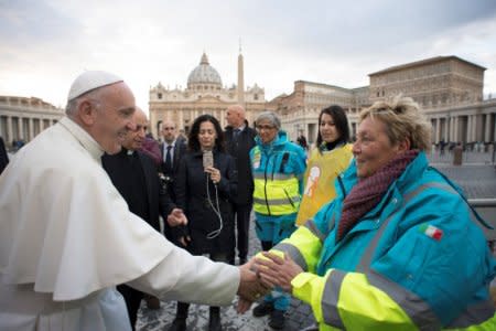 Pope Francis greets medical personnel as he visits a first aid camp set up on the occasion of the World Day of the Poor in front of Saint Peter's square in Rome, Italy November 16, 2017.  Osservatore Romano/Handout via Reuters