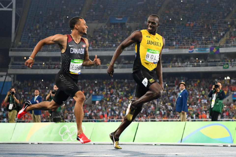 Usain Bolt and Andre de Grasse laugh as they approach the finish line in the Men’s 200m Semifinals.