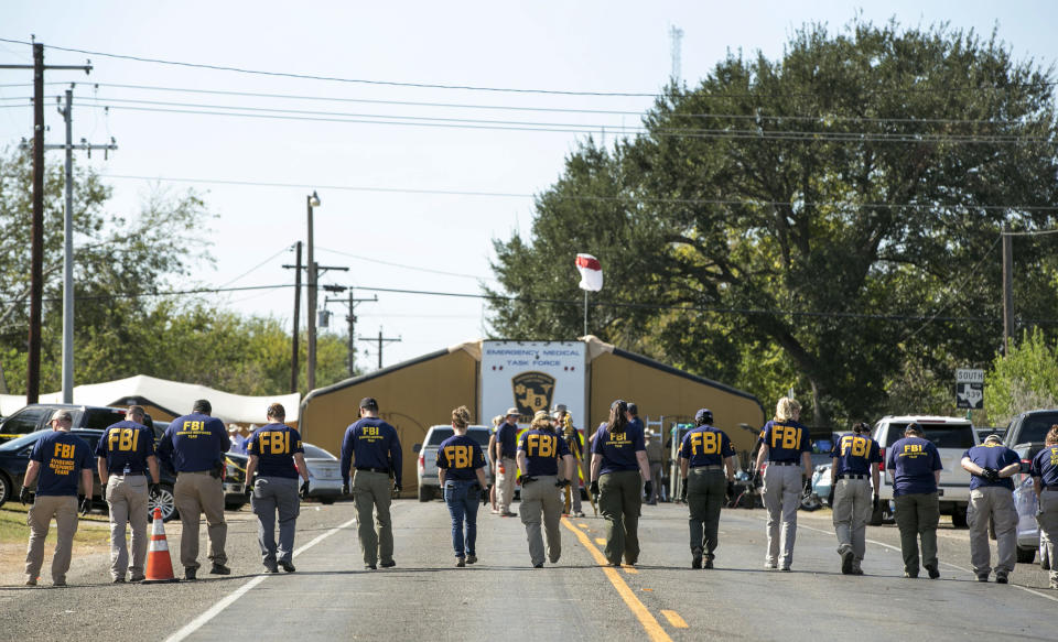 FBI agents inspect the area around the church (Picture: PA)