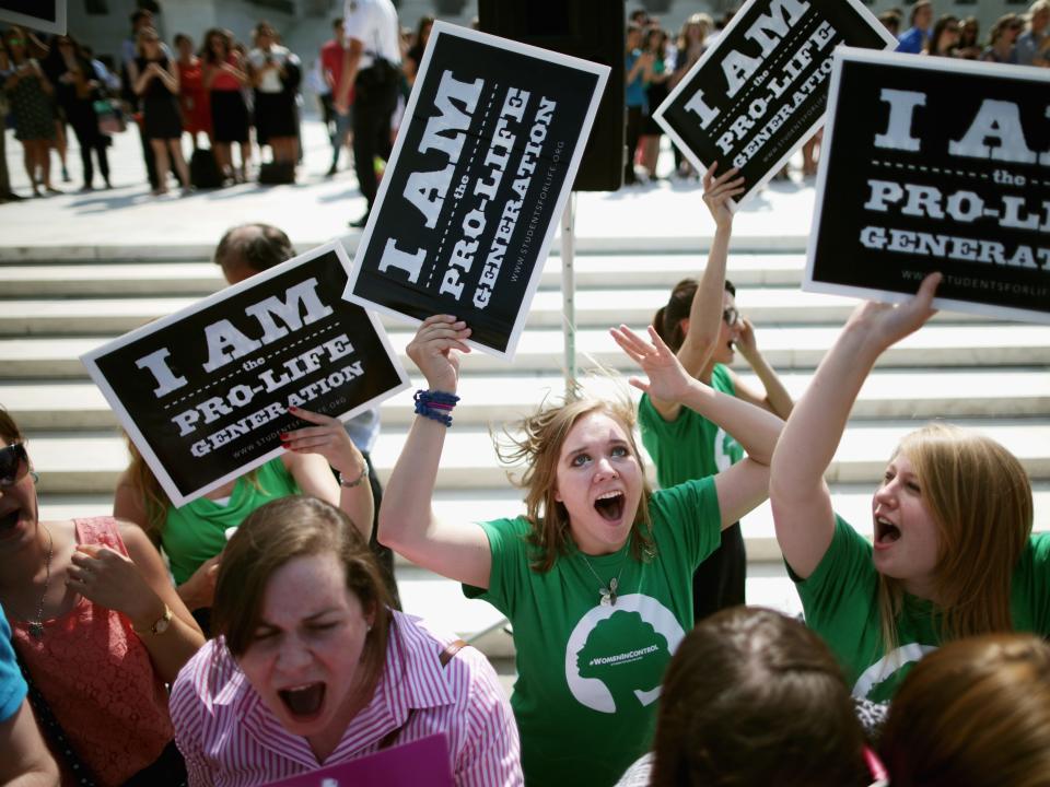 anti abortion activists cheer in front of the supreme court after ruling on burwell v hobby lobby is announced