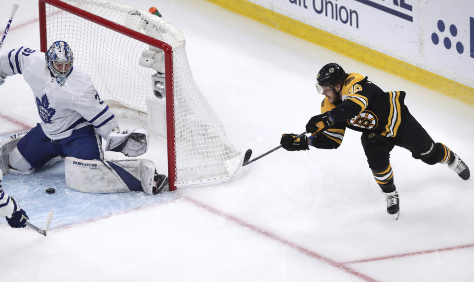 Boston Bruins right wing David Pastrnak, right, fires the puck in front of Toronto Maple Leafs goaltender Frederik Andersen (31) during the first period of Game 7 of an NHL hockey first-round playoff series, Tuesday, April 23, 2019, in Boston. (AP Photo/Charles Krupa)