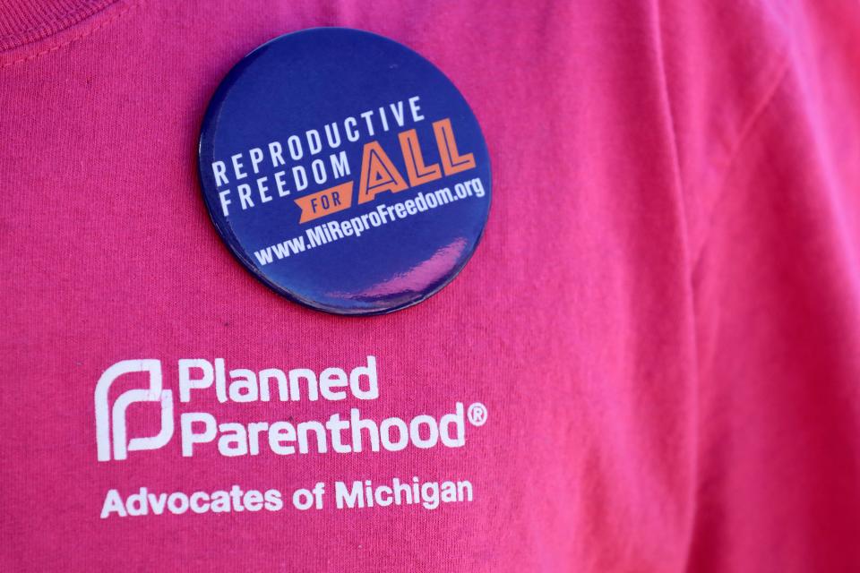 An abortion rights advocate wears a button on their T-shirt in support of the Reproductive Freedom for All proposal.