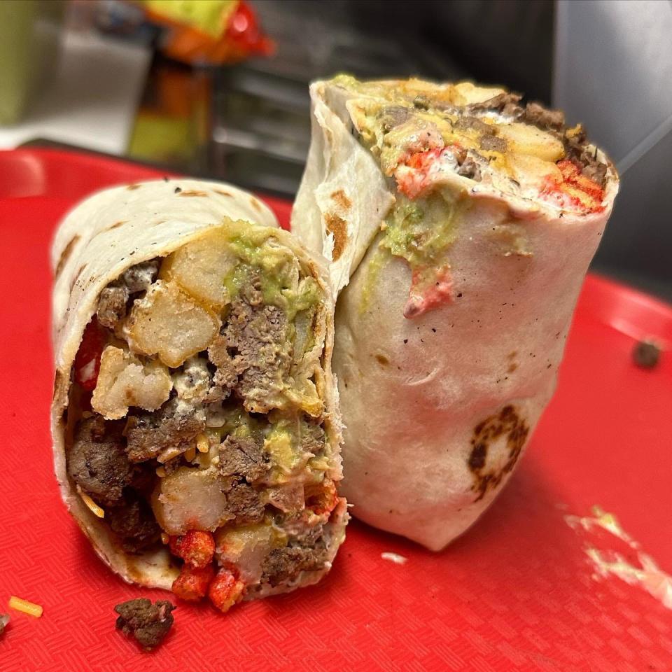 "La Toxica Burrito" at Ceezy F Tacos located at 200 Cuba Avenue. La Toxica Burrito has your choice of meat, pico de gallo, guacamole, french fries, hot cheetos, shredded cheese and nacho cheese.