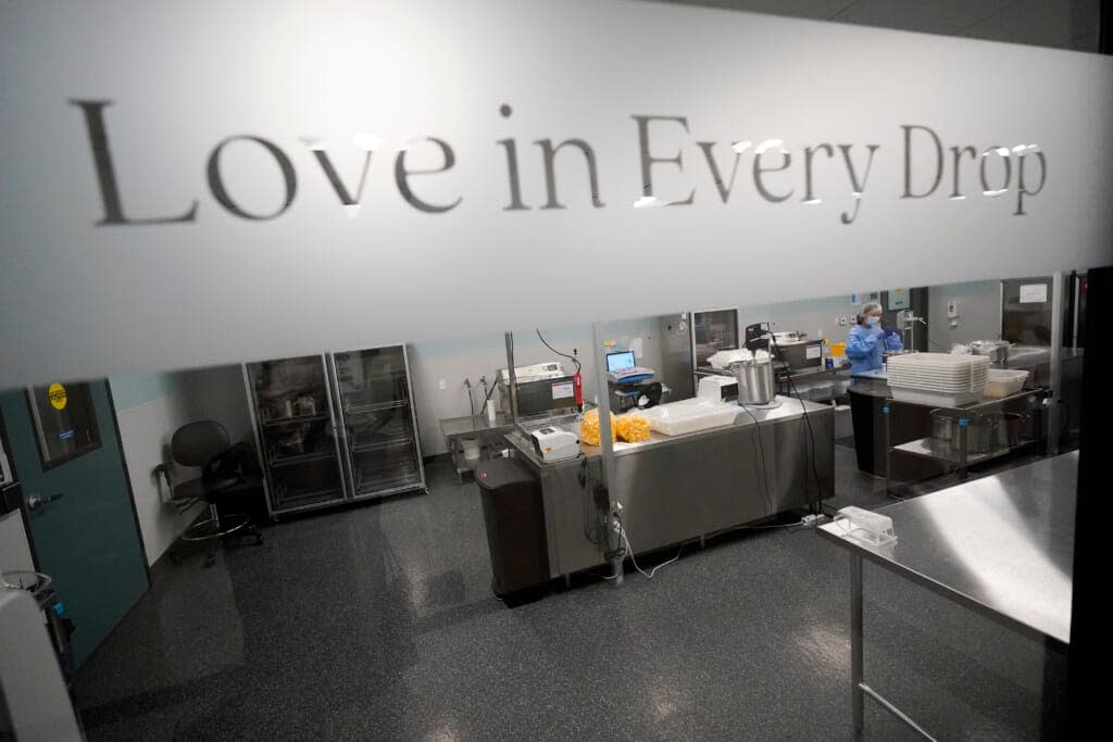 Milk lab technicians Welney Huang processes breast milk at the University of California Health Milk Bank, Friday, May 13, 2022, in San Diego. (AP Photo/Gregory Bull)