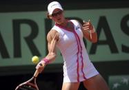 Australia's Samantha Stosur hits a return to Britain's Elena Baltacha after winning their Women's Singles 1st Round tennis match of the French Open tennis tournament at the Roland Garros stadium, in Paris. Stosur, the 2010 runner-up to Francesca Schiavone, took just over an hour to see off the 68th-ranked Baltacha 6-4, 6-0