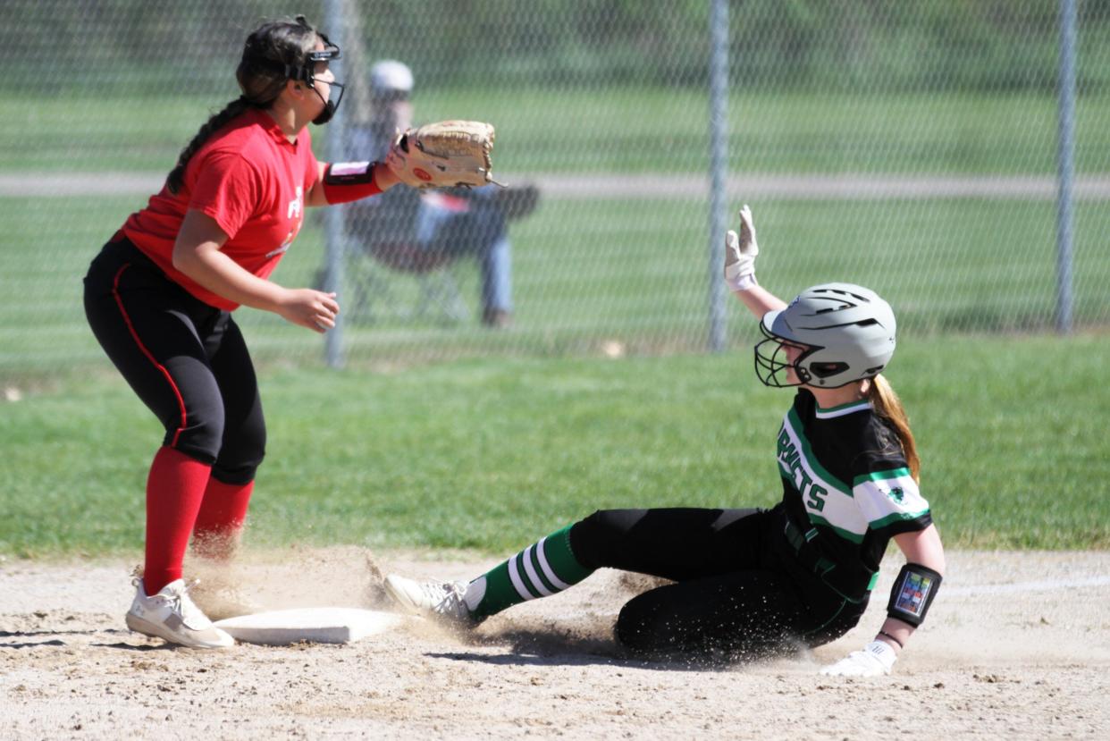 Abby Butler slides safely into third base for a triple for Mendon in the opener.