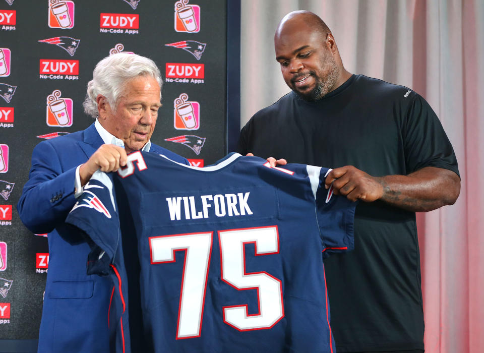 New England Patriots owner Robert Kraft presents a game jersey to former Patriot Vince Wilfork