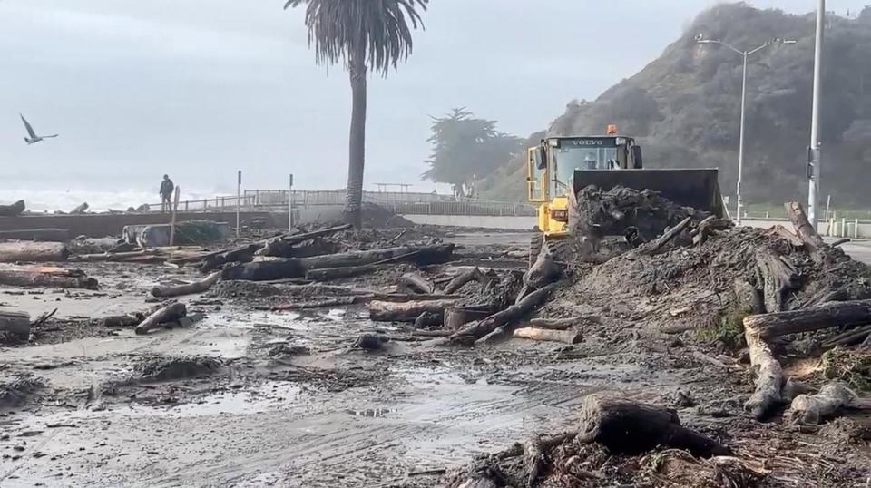 PHOTO: A heavy machinery clears mud and fallen trees off the beach, as massive waves hit the California coastline, in Santa Cruz county, U.S., Dec. 28, 2023, in this screengrab obtained from a handout video.  (County Of Santa Cruz via Reuters)