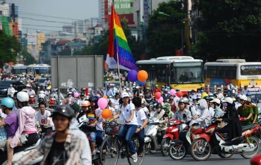 Cyclists decorated with balloons and rainbow flags take part in Vietnam's first ever gay pride parade, in Hanoi, on August 5. The event, organised by the city's small but growing Lesbian Gay Bisexual and Transgender (LGBT) community, went ahead peacefully with no attempt by police to stop the colourful convoy of about 100 activists