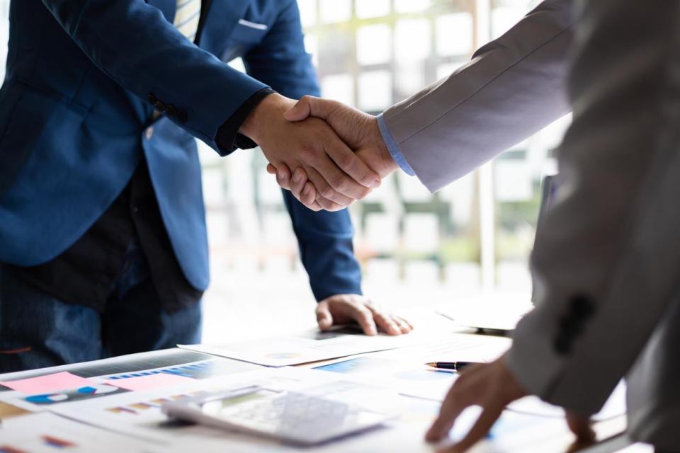 A close up of two people shaking hands. 