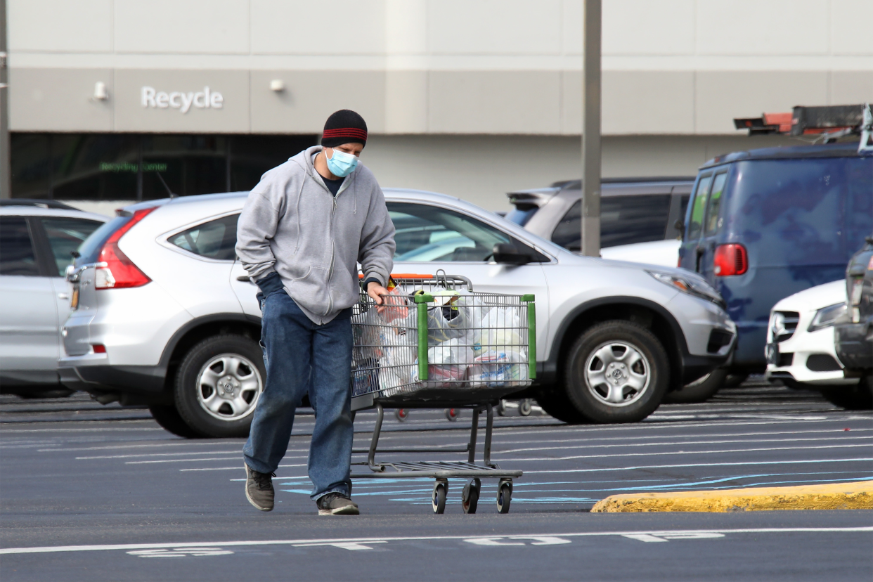 man wearing mask leaving walmart