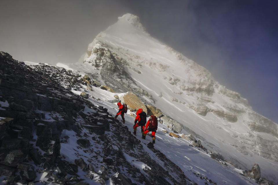 In this photo released by Xinhua News Agency, members of a Chinese surveying team head for the summit of Mount Everest, also known locally as Mt. Qomolangma, Wednesday, May 27, 2020. The Chinese government-backed team plans to summit Mount Everest this week at a time when the world's tallest peak has been closed to commercial climbers. (Tashi Tsering/Xinhua via AP)
