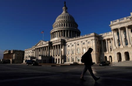 FILE PHOTO: People walk by the U.S. Capitol building in Washington, U.S., February 8, 2018.  REUTERS/Leah Millis/File Photo