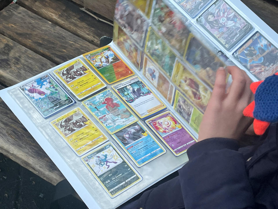 23 January 2023, Berlin: A boy is flipping through his Pokémon card scrapbook. Photo: Stefanie Rex/dpa (Photo by Stefanie Rex/picture alliance via Getty Images)