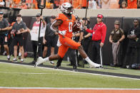 Oklahoma State running back LD Brown (0) runs into the end zone for a touchdown in the first half of an NCAA college football game against Missouri State, Saturday, Sept. 4, 2021, in Stillwater, Okla. (AP Photo/Sue Ogrocki)