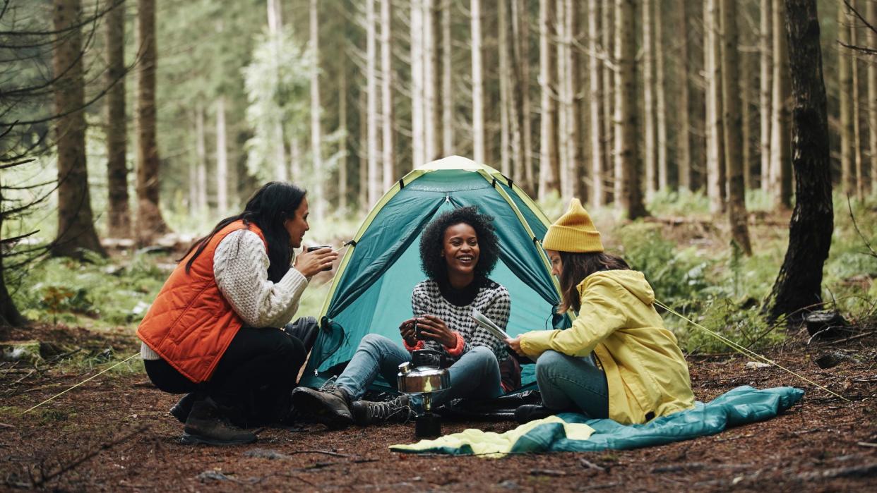  A group of women camping in the woods. 