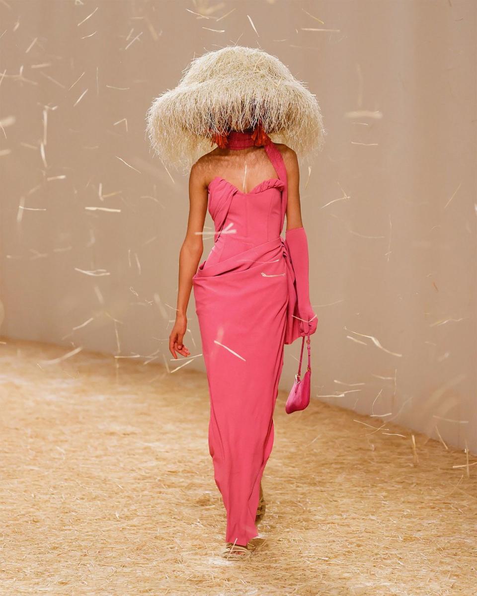 model in pink dress wearing a headpiece that covers her face and looks like a beige sea urchin but is very couture 1950s like