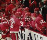 FILE - Detroit Red Wings defender Vladimir Konstantinov (16) is congratulated by teammates after his second period goal against the Colorado Avalanche in Denver, Thursday, May 23, 1996. The Boston Bruins are chasing the records for the most wins and points in an NHL regular season. Members of the 1976-77 Montreal Canadiens, '95-96 Detroit Red Wings and 2018-19 Tampa Bay Lightning who hold one or both of them know what it’s like to be that dominant and see plenty of parallels between what they accomplished and what the Bruins are doing. (AP Photo/Joe Mahoney, File)