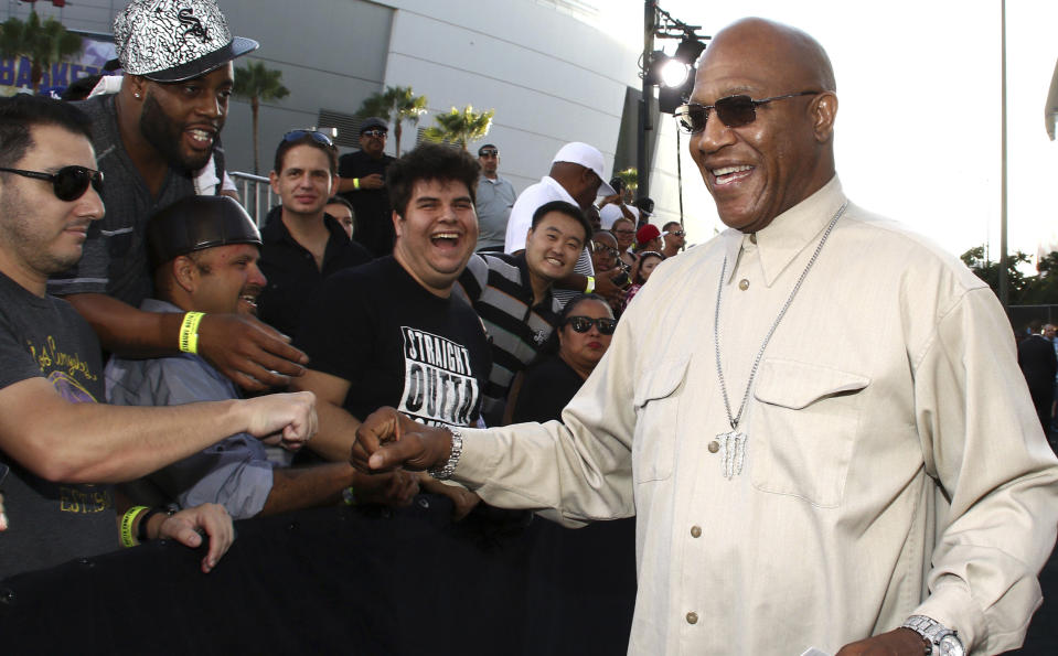 FILE - In this Monday, Aug. 10, 2015 file photo, Tommy 'Tiny' Lister greets fans as he arrives at the Los Angeles premiere of "Straight Outta Compton" at the Microsoft Theater. Tommy “Tiny” Lister, a former wrestler who was known for his Deebo character in the “Friday” films, has died. He was 62. Lister manager, Cindy Cowan, said Lister was found unconscious in his home in Marina Del Rey, California, on Thursday, Dec. 10, 2020. He was pronounced dead at the scene. (Photo by John Salangsang/Invision/AP, File)